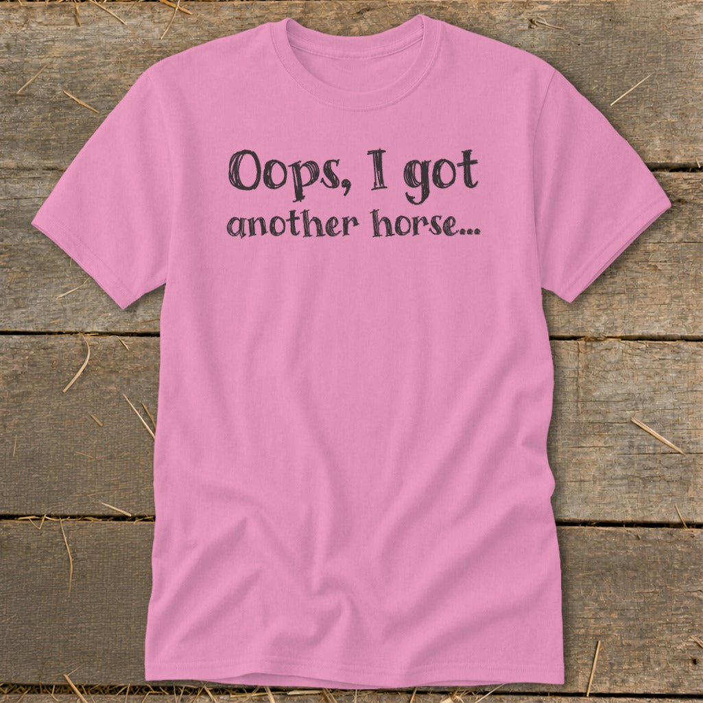 Pink t-shirt with black text that reads "Oops, I got another horse..."
