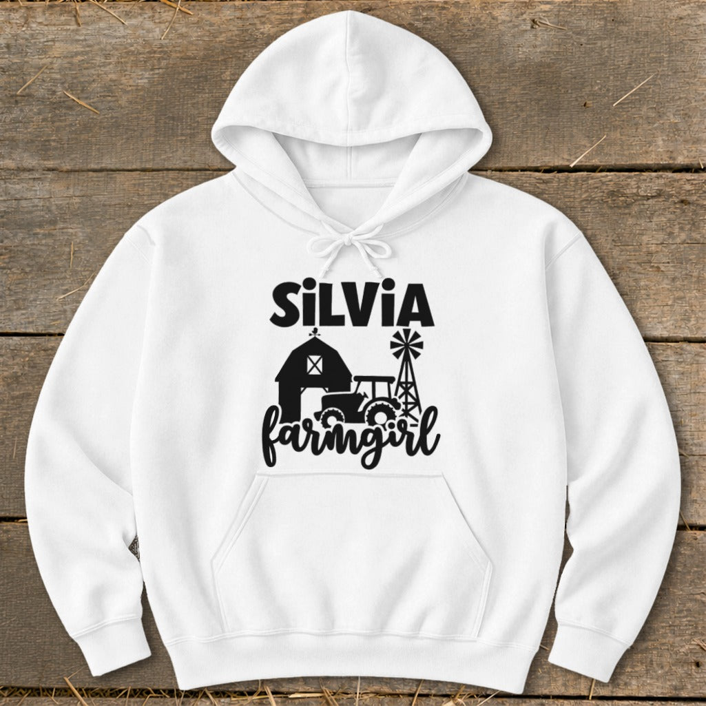 White hoodie with black "Silvia Farmgirl" text and farm graphics.