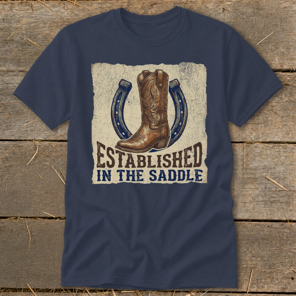 Navy t-shirt with a cowboy boot and horseshoes design that reads "Established in the Saddle".