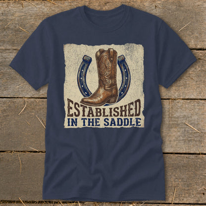 Navy t-shirt with a cowboy boot and horseshoes design that reads "Established in the Saddle".