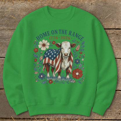 Cow draped in American flag surrounded by flowers and text "HOME ON THE RANGE 1776-2026".