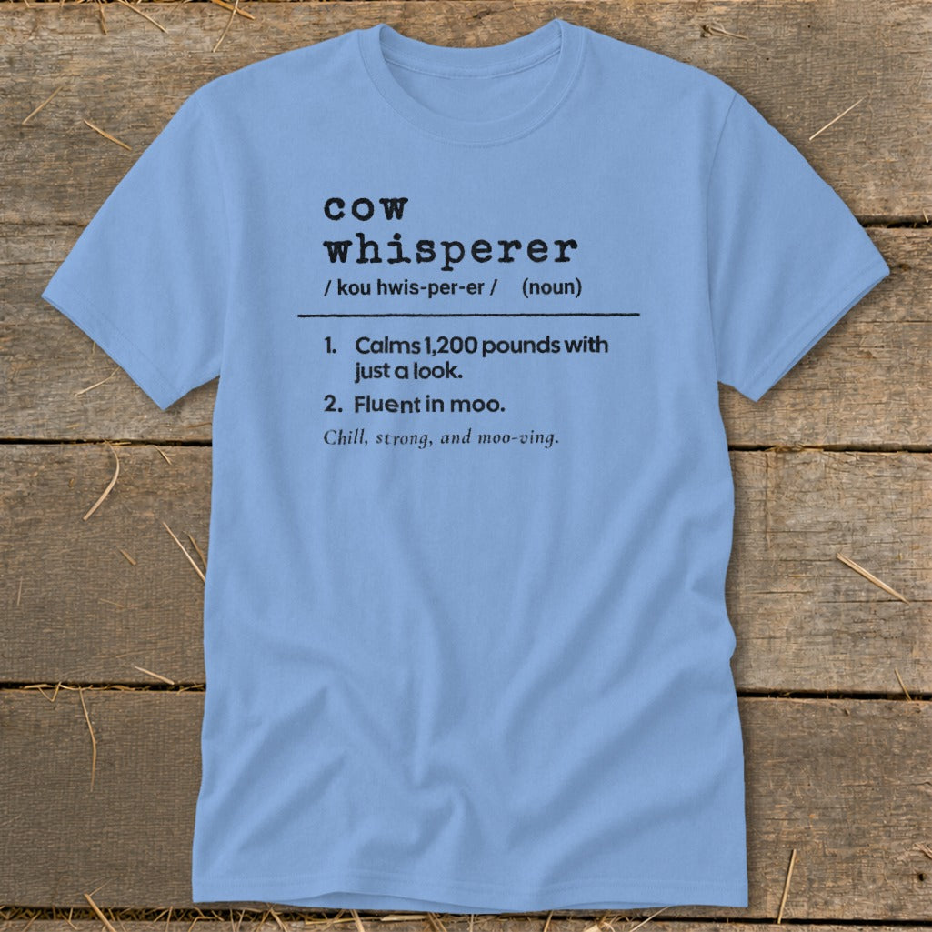 Light blue t-shirt with "Cow Whisperer" definition and funny cow-related phrases.
