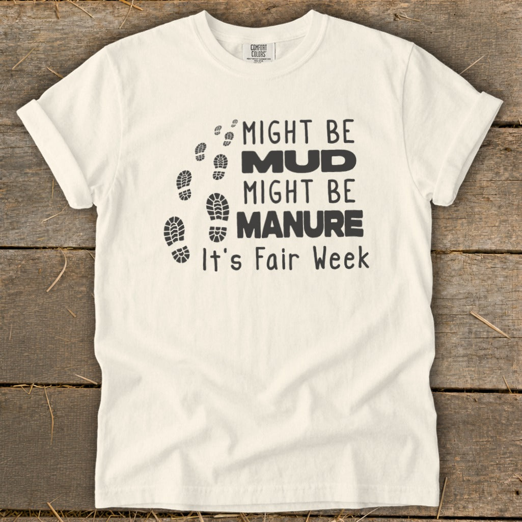 Cream t-shirt with footprints and text: "Might be Mud, Might be Manure. It's Fair Week."