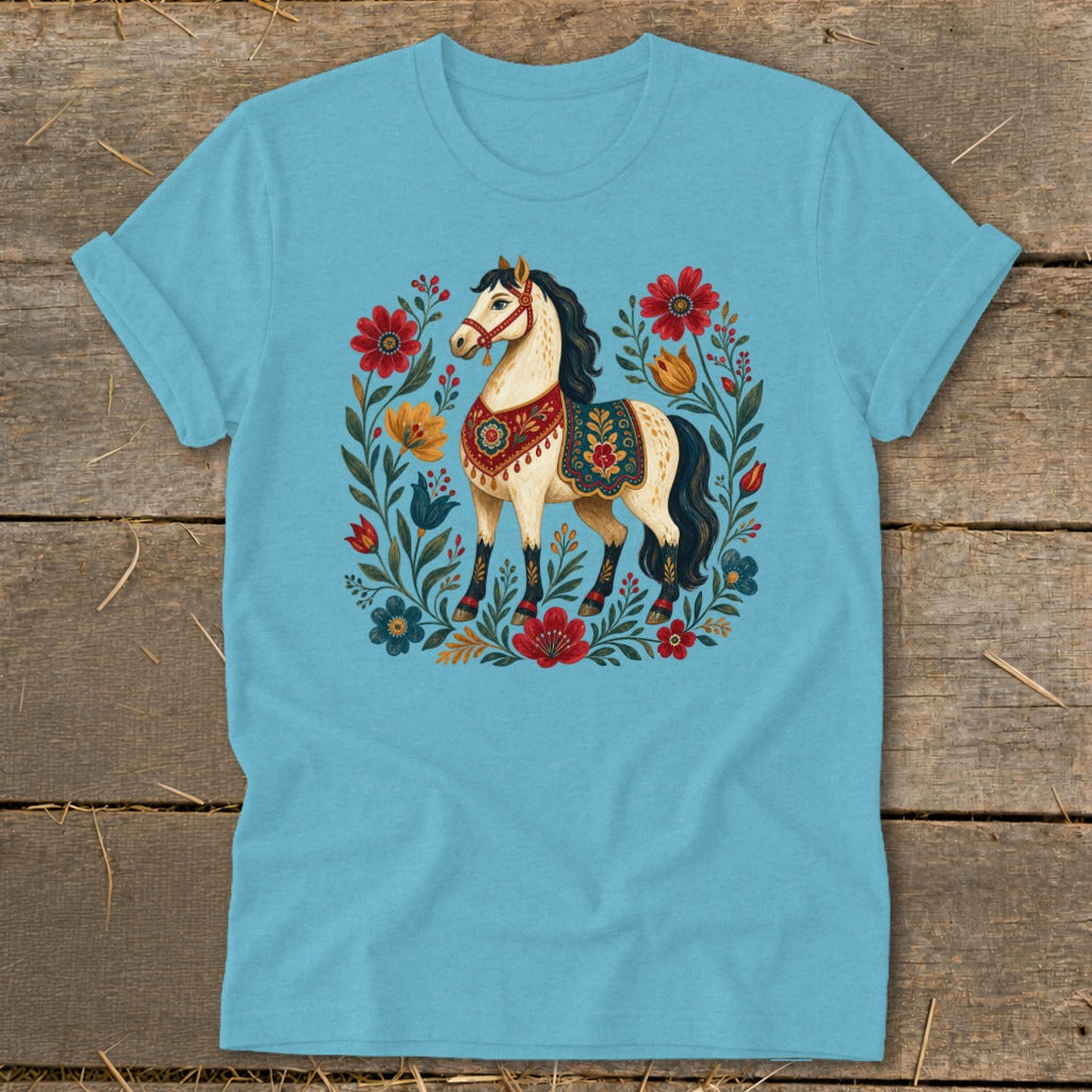 Light blue t-shirt with a decorative horse surrounded by colorful flowers.