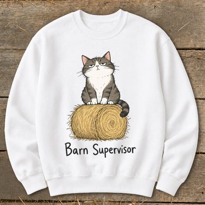 White sweatshirt with cartoon cat on hay bale, text "Barn Supervisor".