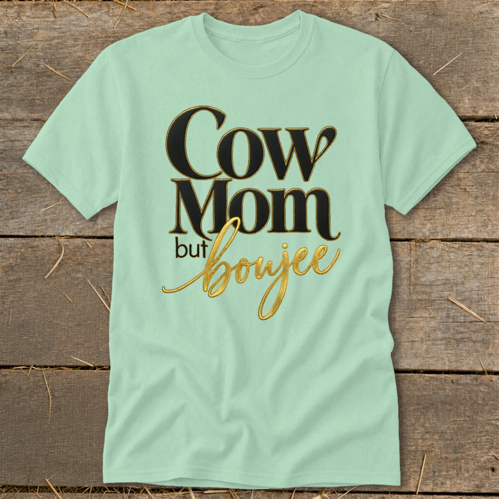 Light green t-shirt with black and gold text reading "Cow Mom but boujee."