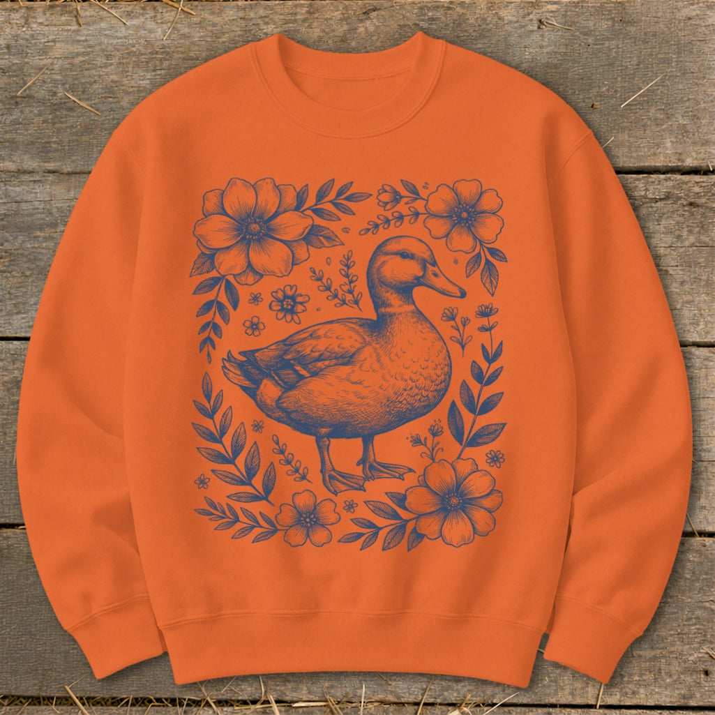 Orange crewneck sweatshirt with blue duck and floral illustration.