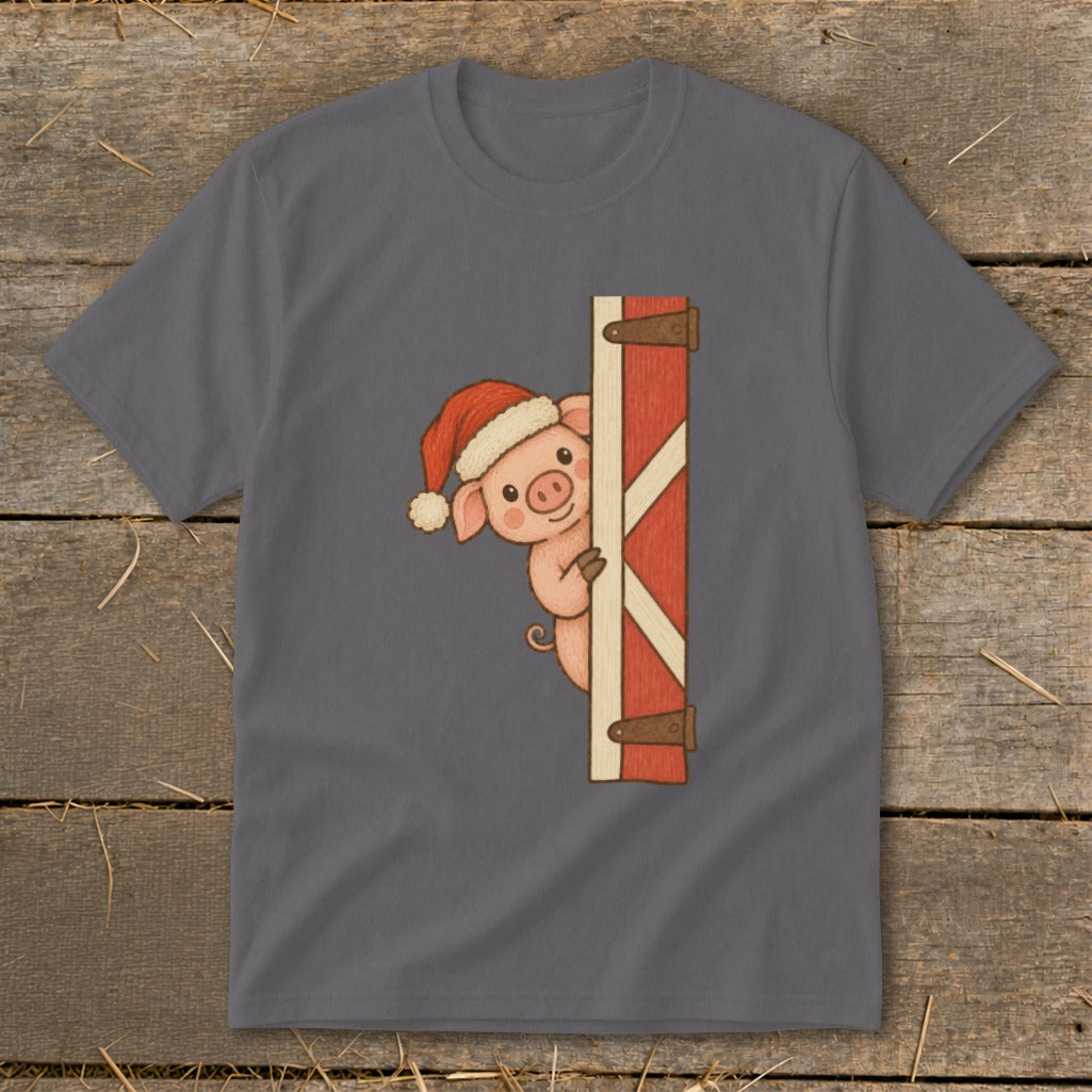 Pig wearing Santa hat peeking around a barn door on a t-shirt.
