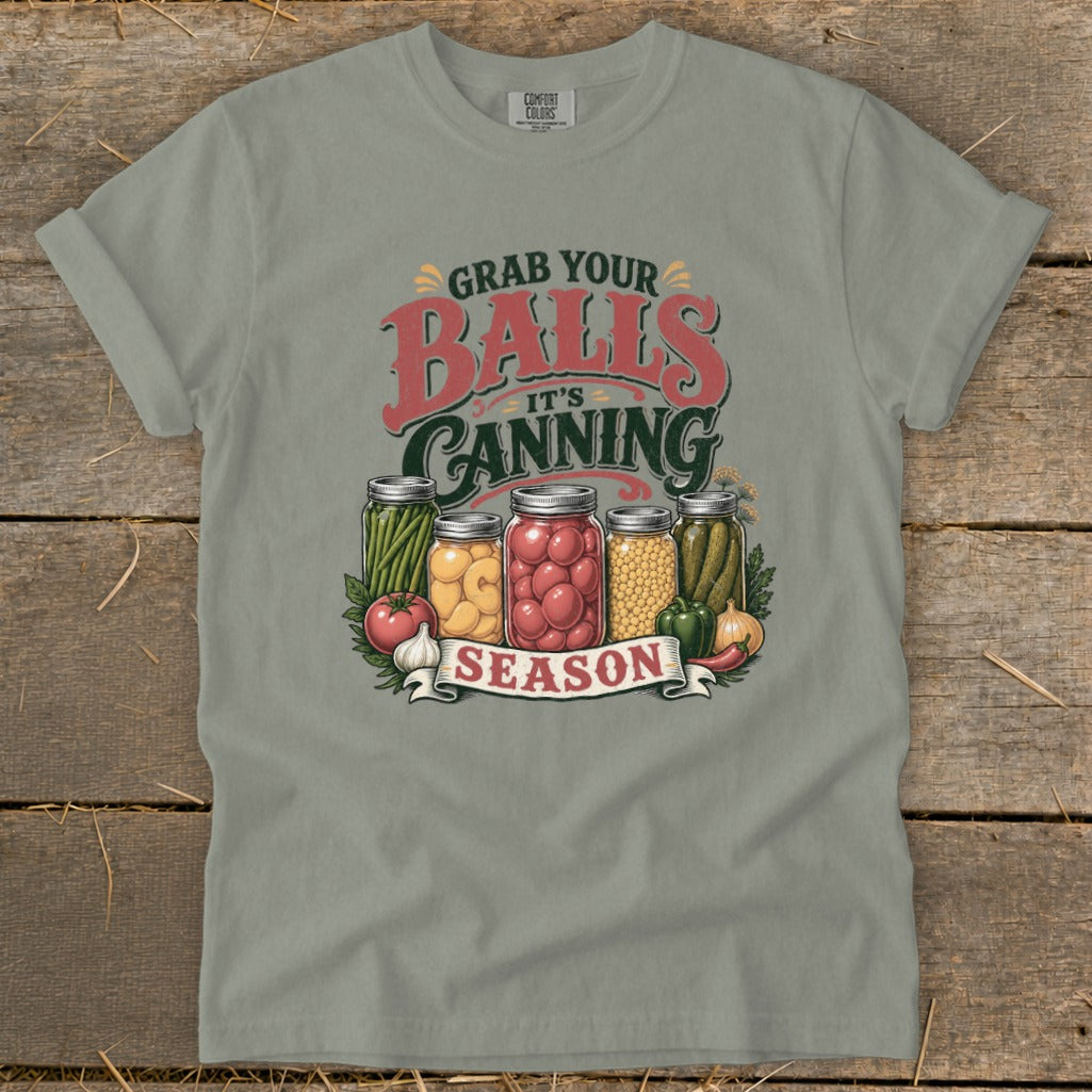 T-shirt graphic with jars of pickled vegetables and text "Grab Your Balls It's Canning Season."