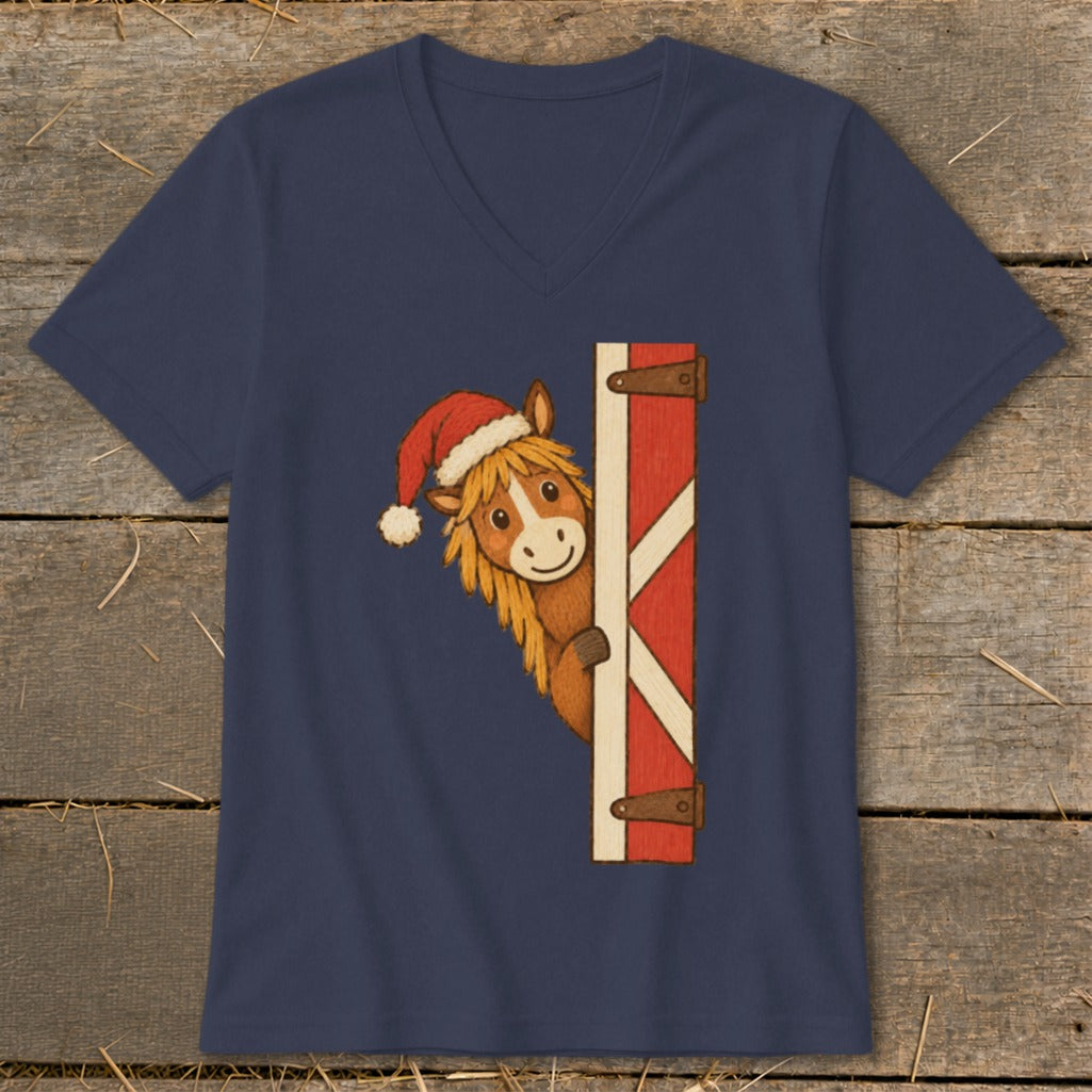 Cartoon horse wearing Santa hat peeking from behind barn door on navy t-shirt.