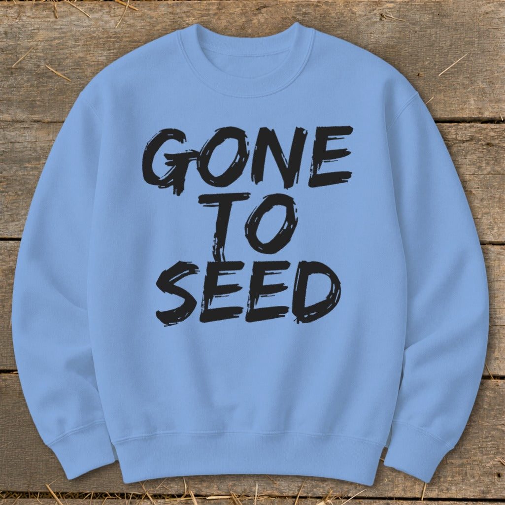 Light blue sweatshirt with black brush stroke text reading "GONE TO SEED".