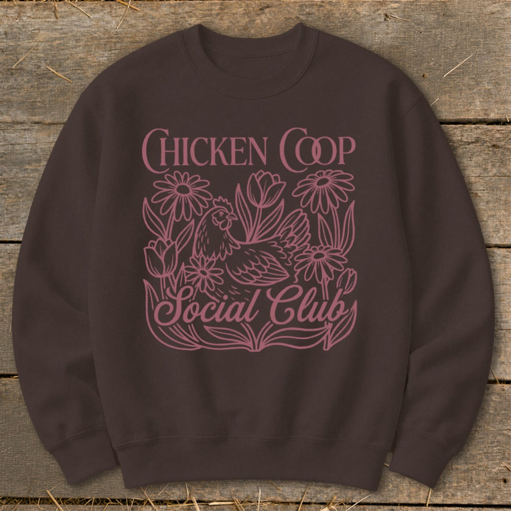 Brown sweatshirt with pink "Chicken Coop Social Club" text and a chicken with flowers.