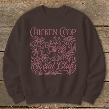 Brown sweatshirt with pink "Chicken Coop Social Club" text and a chicken with flowers.