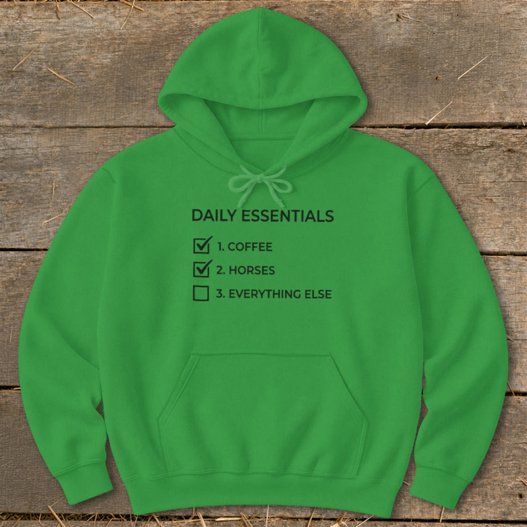 Green hoodie with "Daily Essentials: 1. Coffee, 2. Horses, 3. Everything Else" text.