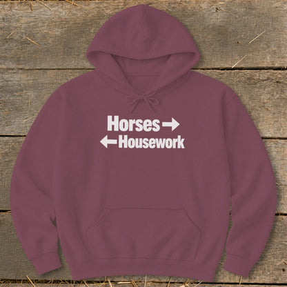 Maroon pullover hoodie with a front pocket, featuring white text that reads Horses with a right arrow and Housework with a left arrow.