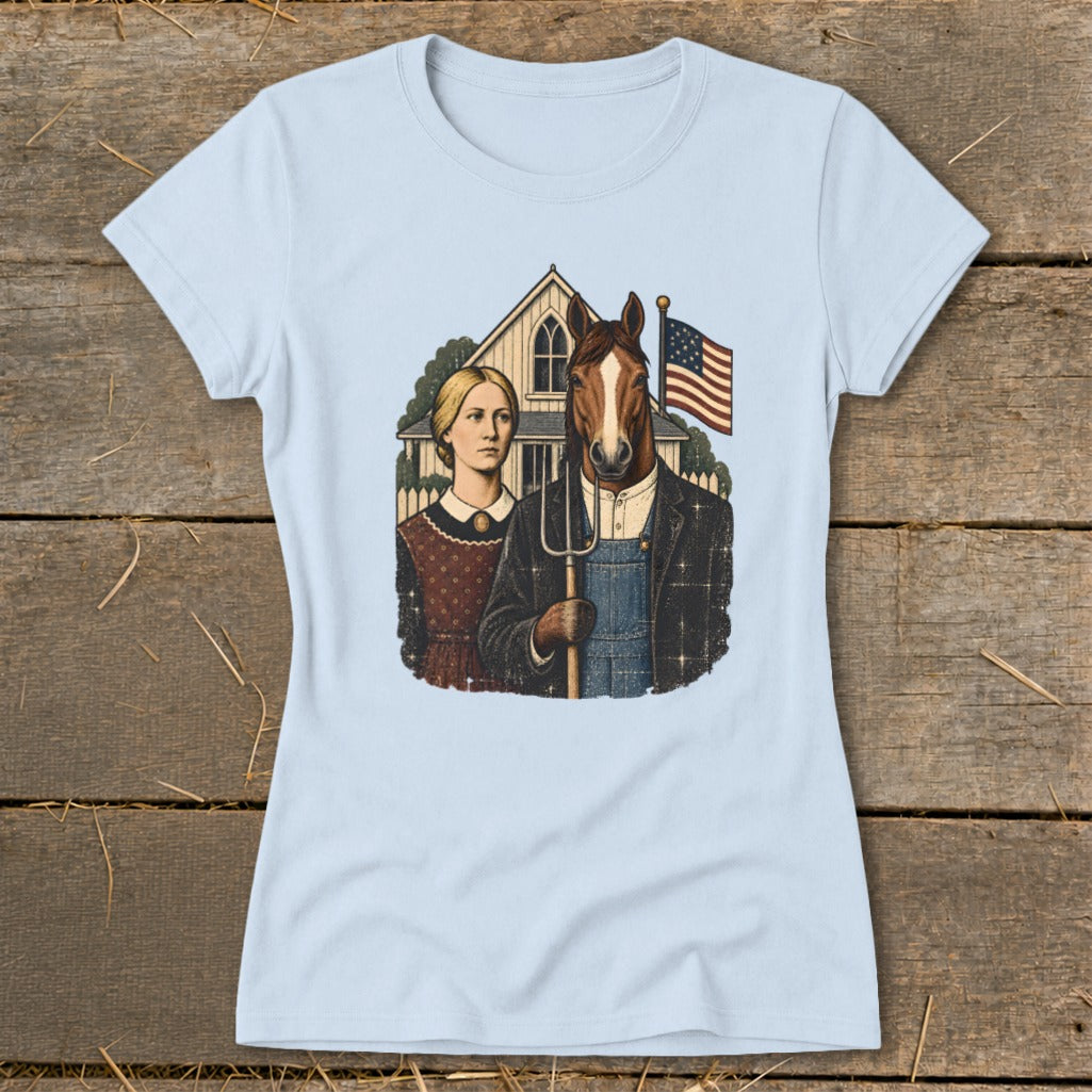 A light blue t-shirt printed with a parody of American Gothic featuring a woman and a horse-headed farmer holding a pitchfork.