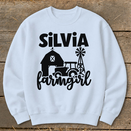 White sweatshirt with "Silvia farmgirl" text and farm graphics.