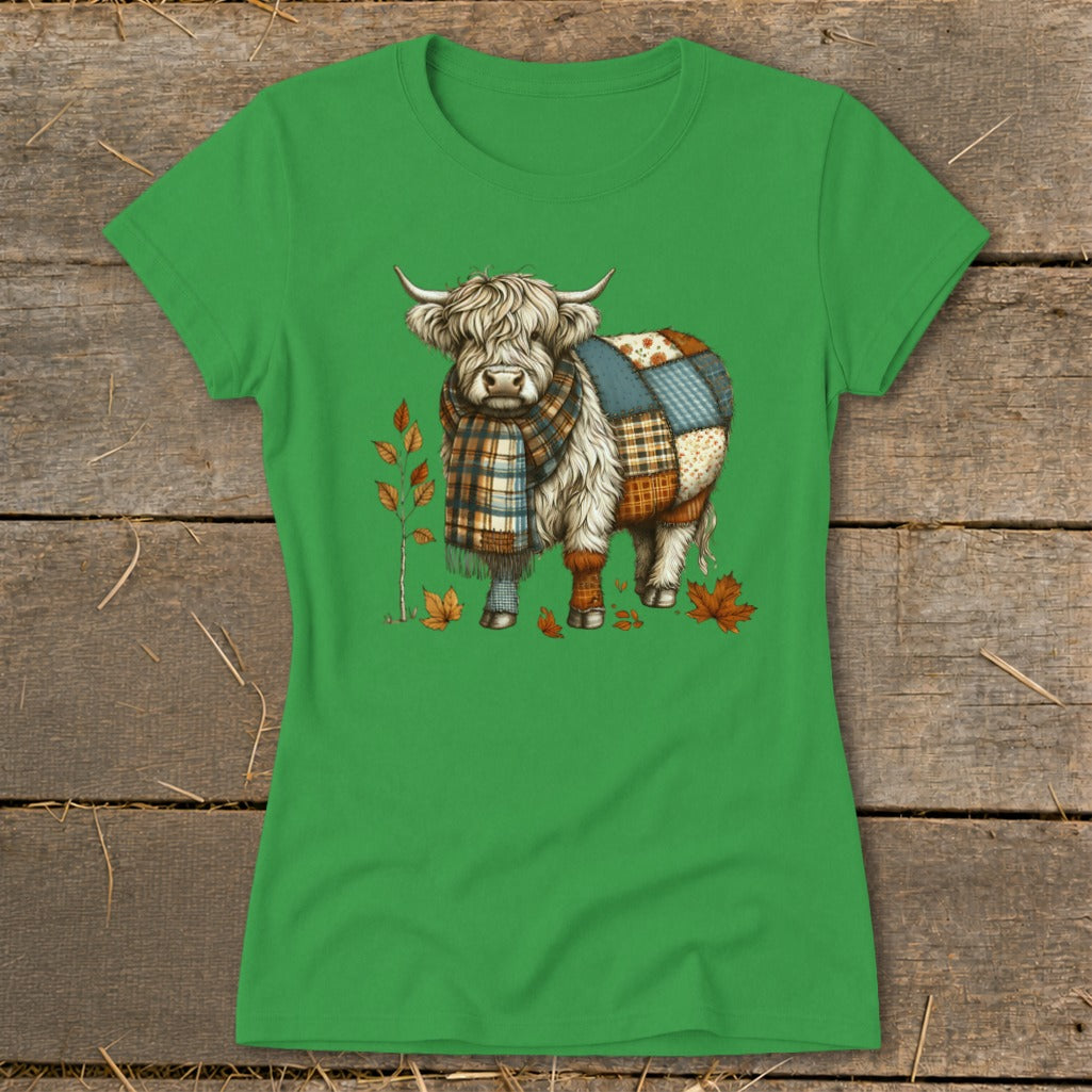 Highland cow with patchwork body and plaid scarf among autumn leaves.