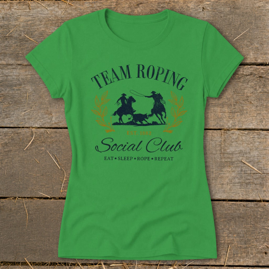 Green t-shirt with "Team Roping Social Club" and cowboy graphics.