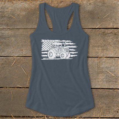 White tractor graphic on distressed American flag print on a dark grey racerback tank top.