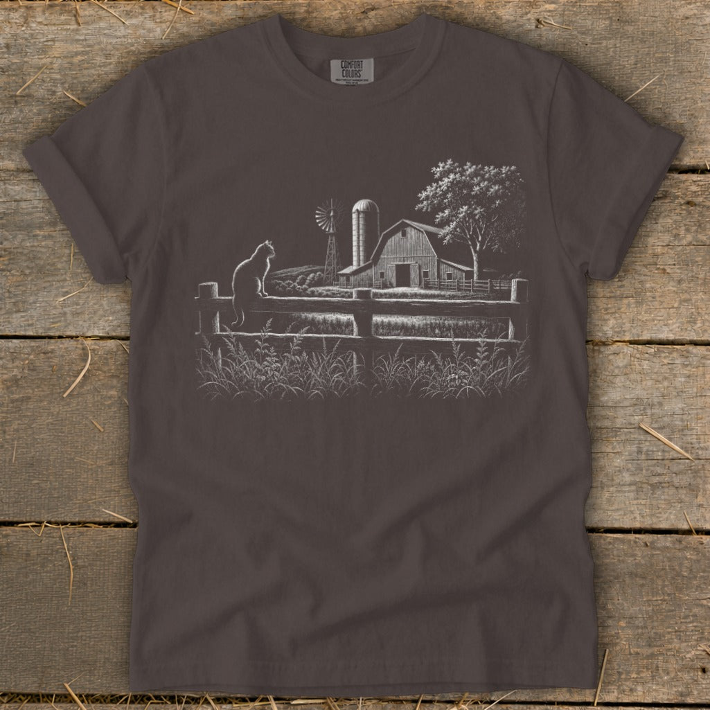 T-shirt with a sketch of a cat on a fence in front of a barn and windmill.