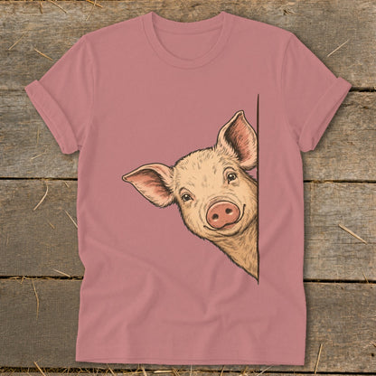 Pig peeking around a corner on a pink t-shirt.