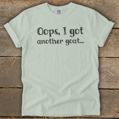 Light green t-shirt with black text: "Oops, I got another goat..."