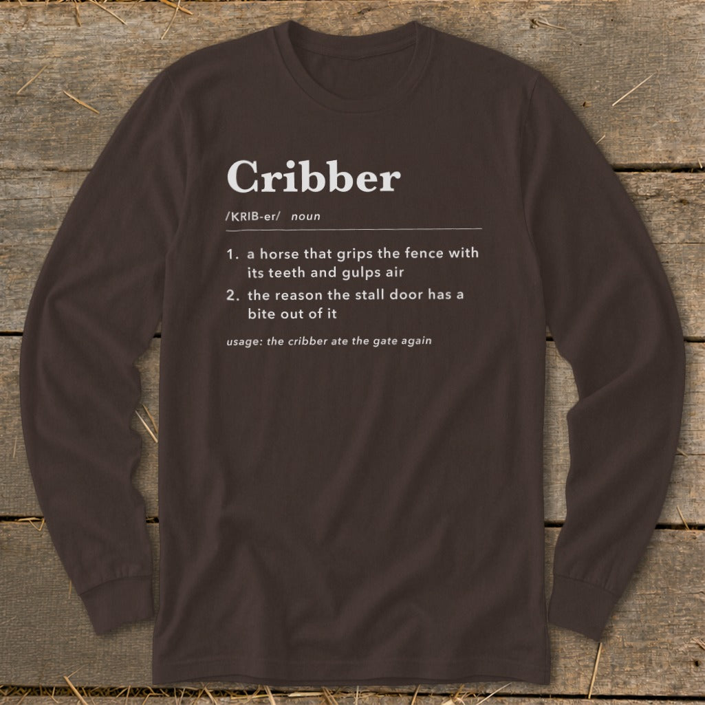 A dark brown long-sleeve t-shirt with dictionary definition text for the word Cribber printed on the chest.