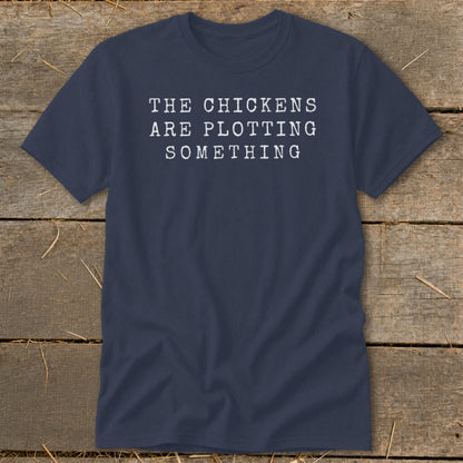 Navy t-shirt with white text "THE CHICKENS ARE PLOTTING SOMETHING".