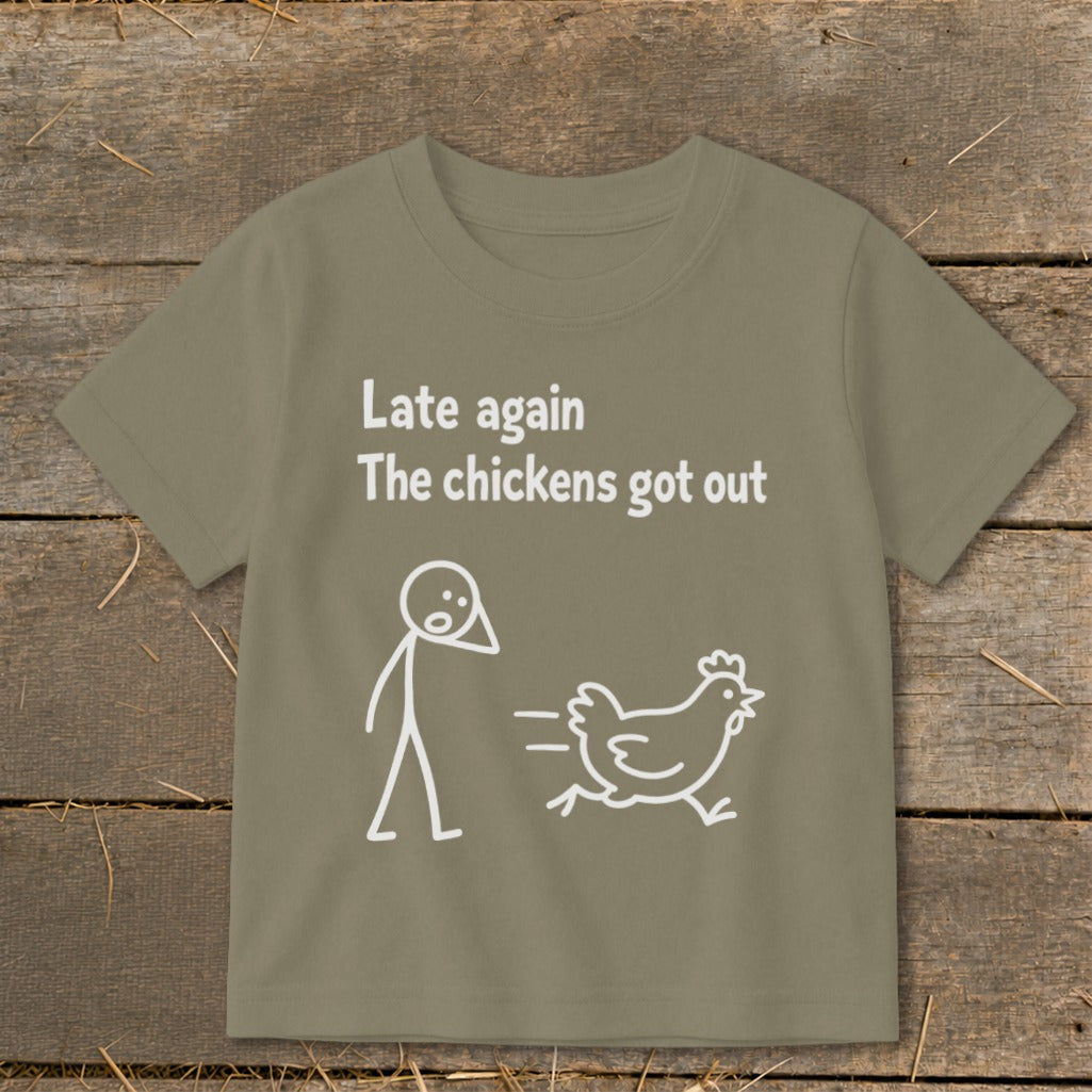 Kid's t-shirt with text "Late again The chickens got out" and stick figures.