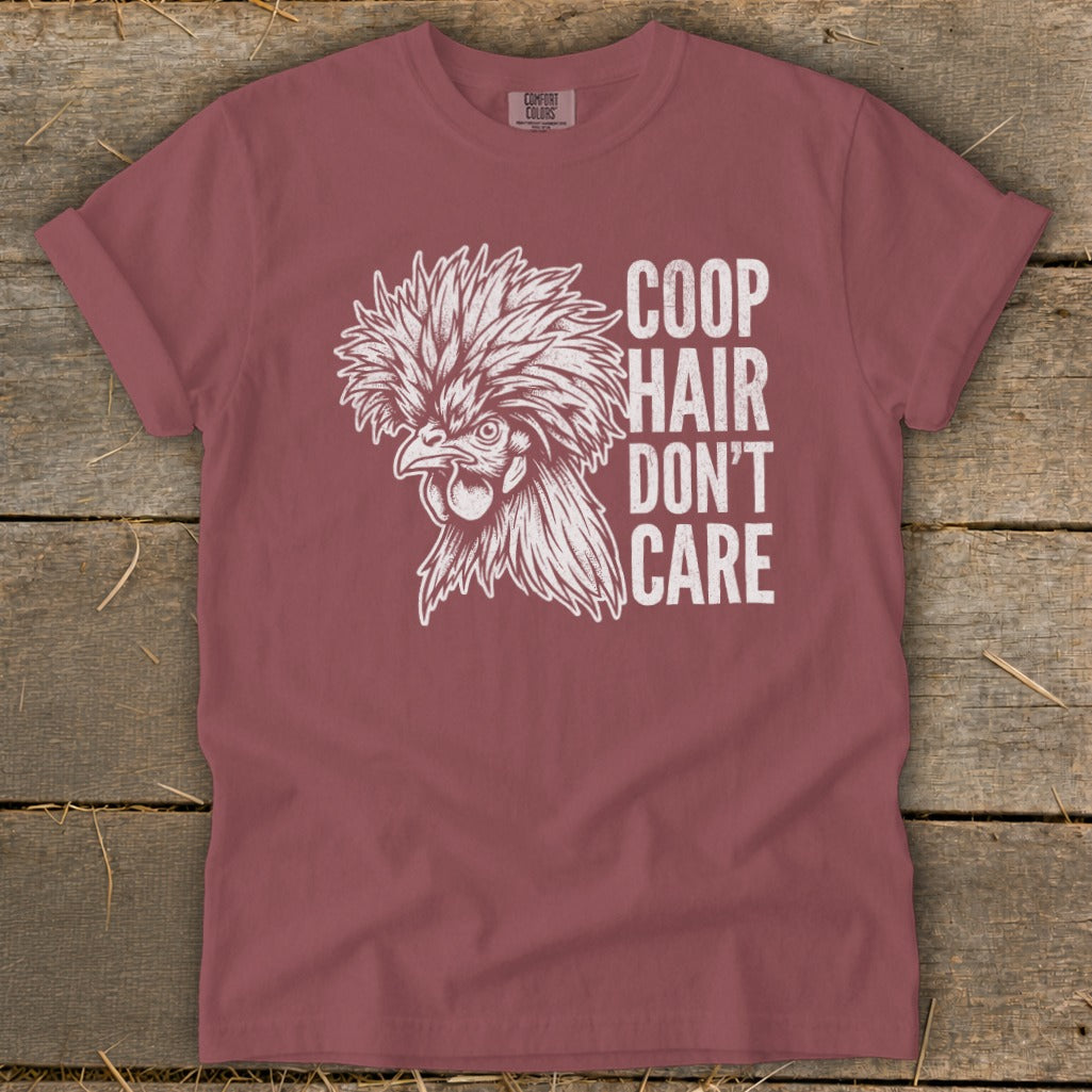 Maroon t-shirt with a drawing of a fluffy chicken and text "COOP HAIR DON'T CARE".