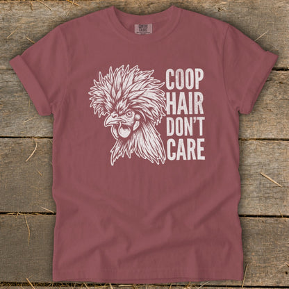 Maroon t-shirt with a drawing of a fluffy chicken and text "COOP HAIR DON'T CARE".