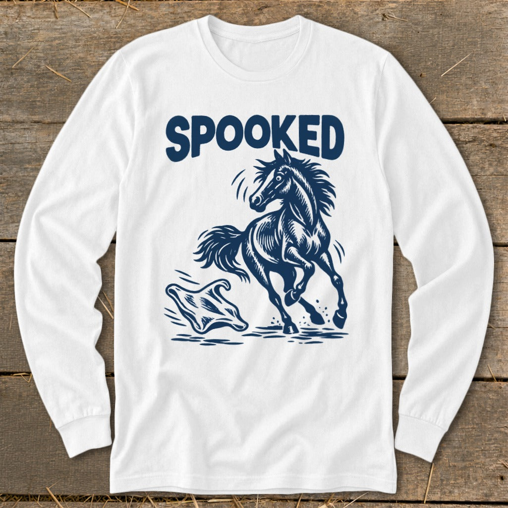 White long-sleeve shirt with blue "SPOOKED" text and a startled horse running from a ghost.