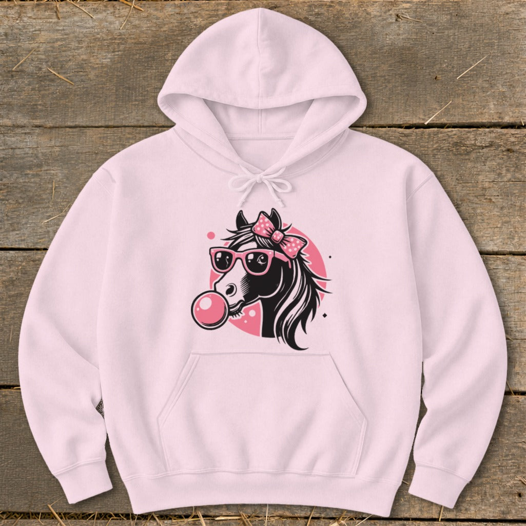 Pink hoodie with a cartoon horse wearing sunglasses and a bow blowing bubblegum.