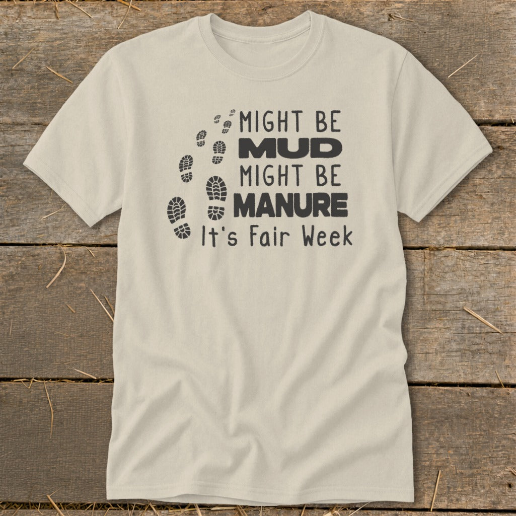 Cream t-shirt with "Might be Mud, Might be Manure, It's Fair Week" and footprints.