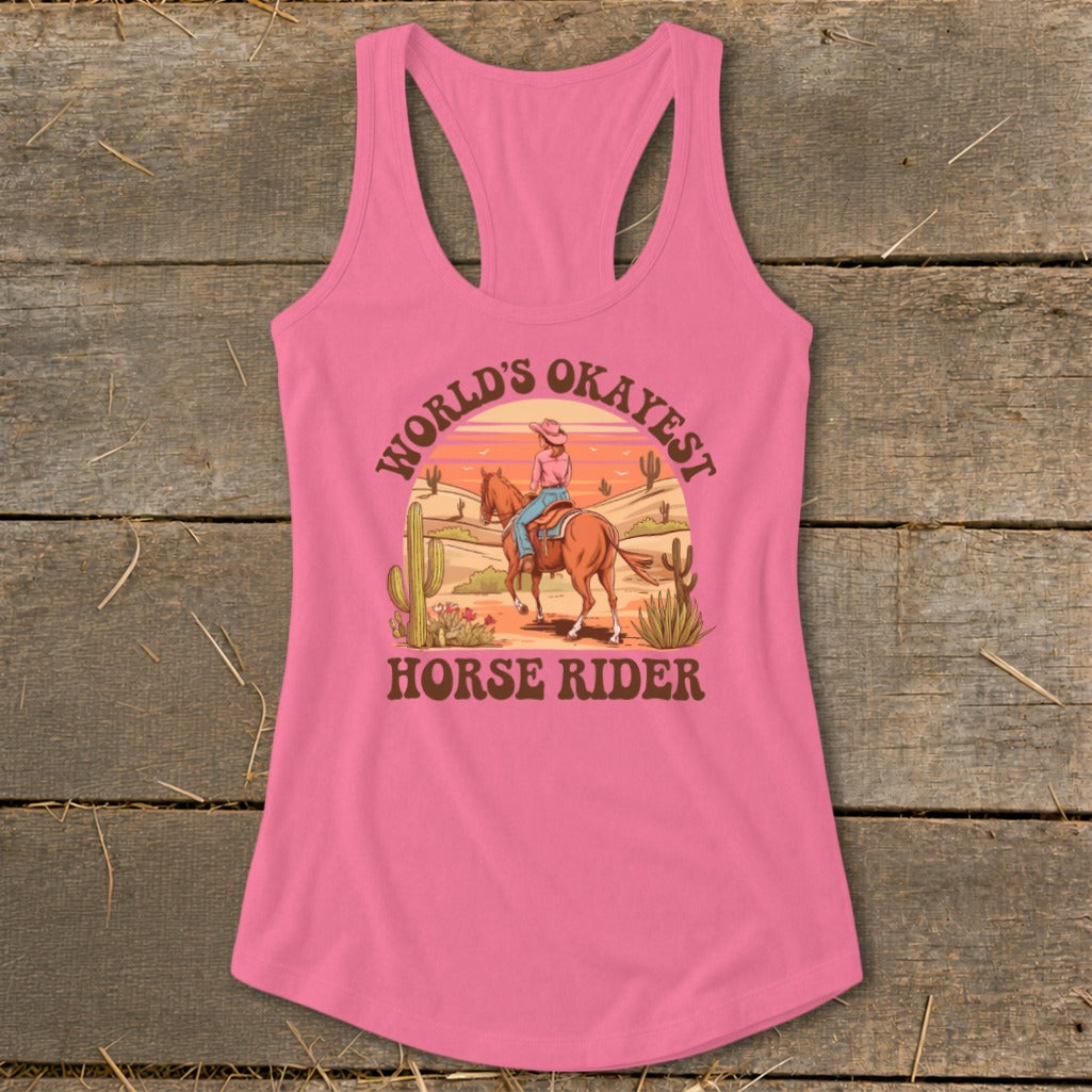 Pink tank top with "World's Okayest Horse Rider" graphic of a person on a horse in a desert.