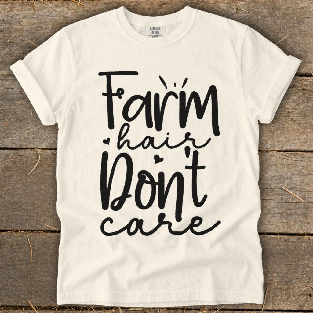 Cream t-shirt with black text that reads "Farm hair Don't care".
