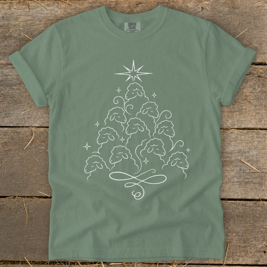 Green t-shirt with white outline of sheep forming a Christmas tree shape.