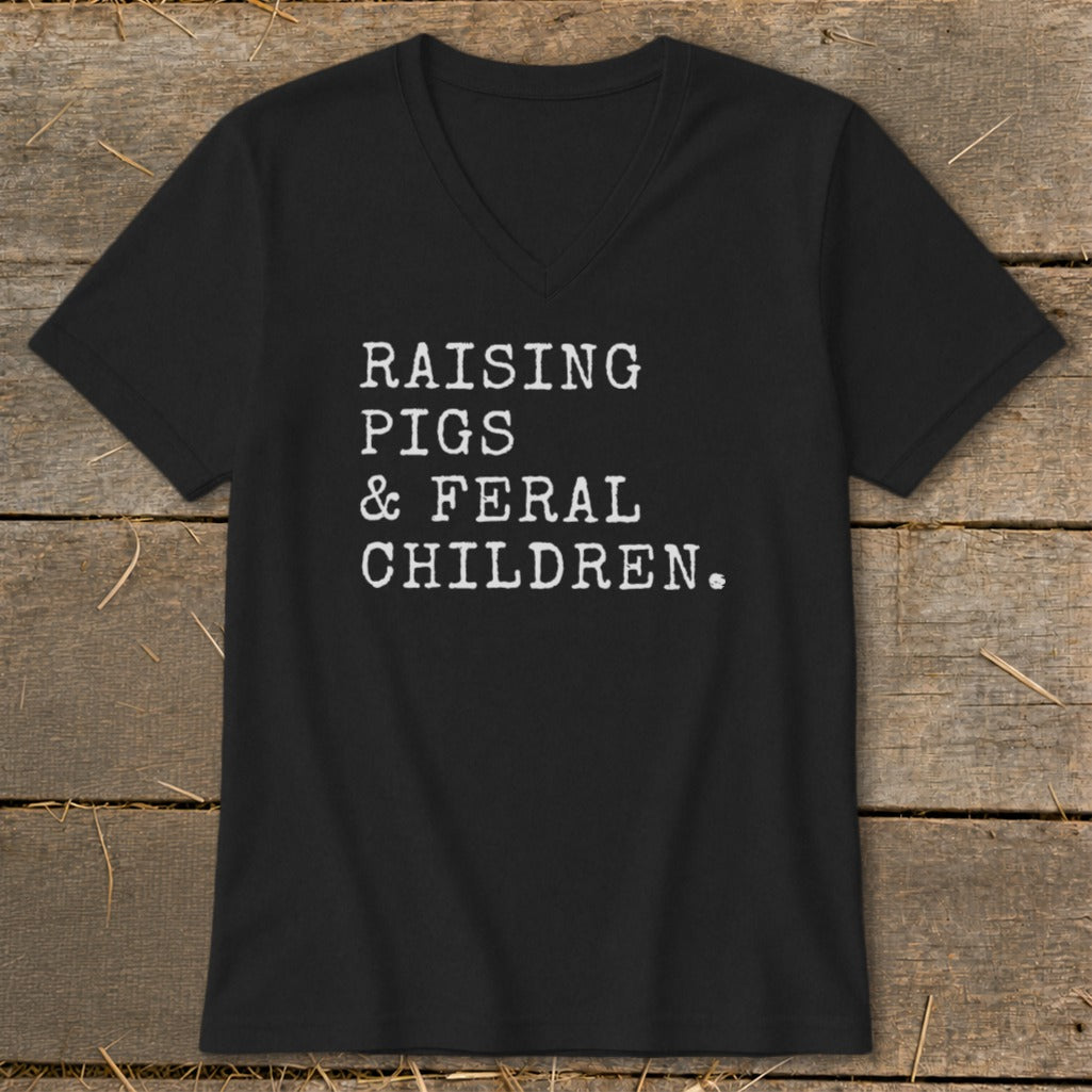 Black t-shirt with white text "RAISING PIGS & FERAL CHILDREN."