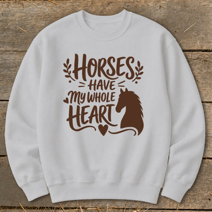 White sweatshirt with brown graphic "Horses Have My Whole Heart" and horse silhouette.