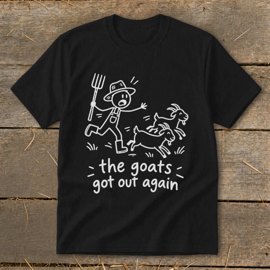 Black t-shirt with white line drawing of a farmer chasing two goats and text "the goats got out again".