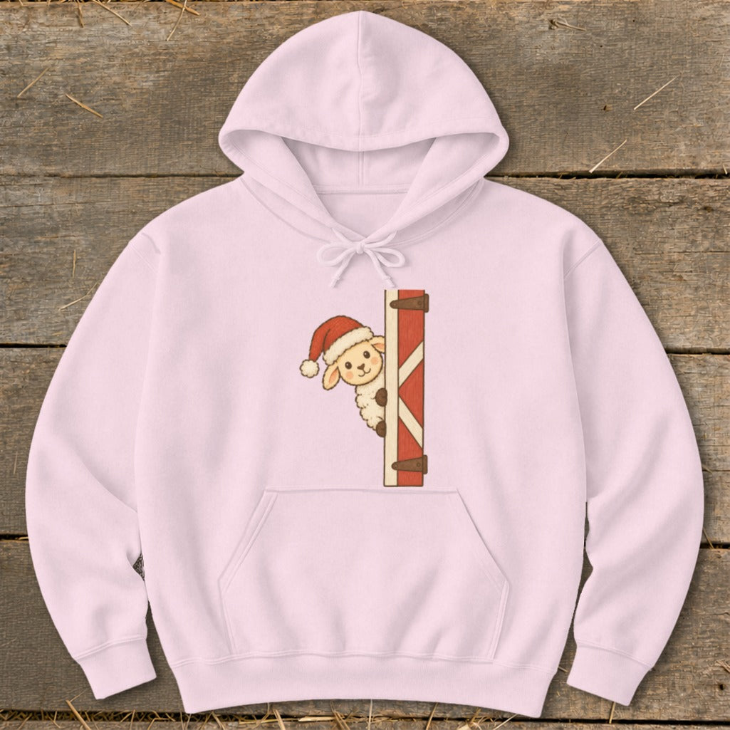 Pink hoodie with a cute cartoon sheep wearing a Santa hat peeking from behind a barn door.
