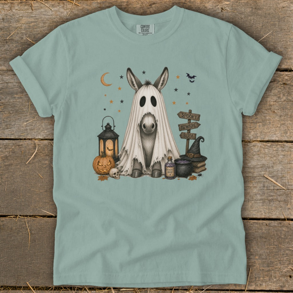 Donkey in ghost costume with Halloween decorations and spooky sign.