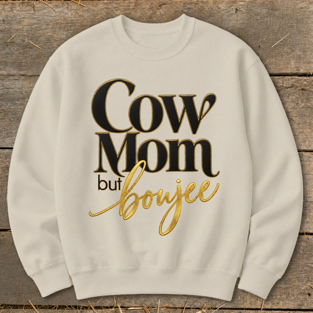 Cream sweatshirt with "Cow Mom but boujee" text in black and gold.