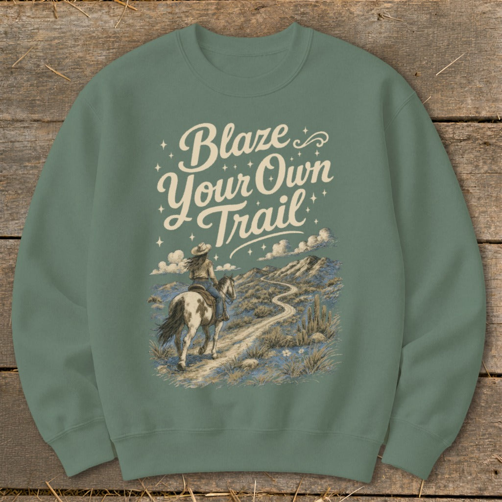 Crewneck sweatshirt with "Blaze Your Own Trail" text over a desert scene with a person on horseback.