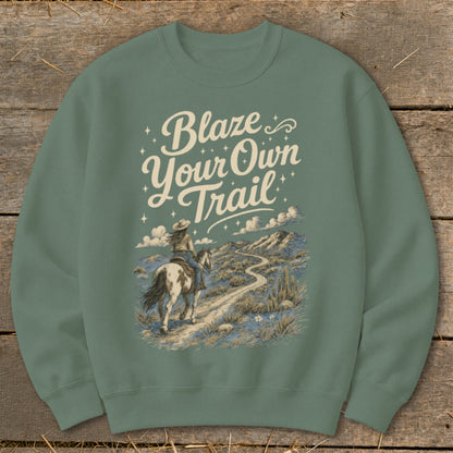 Crewneck sweatshirt with "Blaze Your Own Trail" text over a desert scene with a person on horseback.