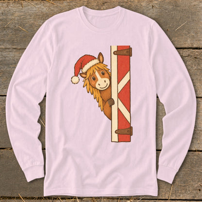 Christmas horse wearing a Santa hat peeking from behind a barn door.