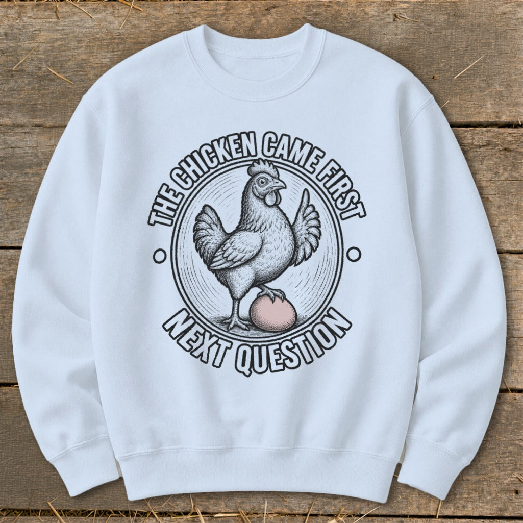 White sweatshirt with "The chicken came first. Next question." text and chicken graphic.