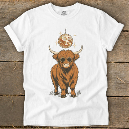Highland cow with sunglasses and disco ball graphic on white t-shirt.
