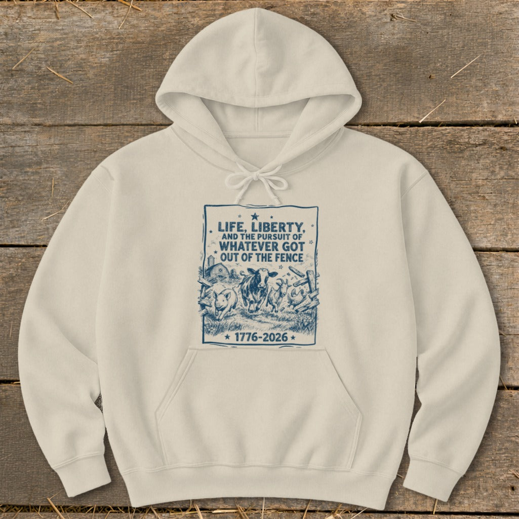 Cream hoodie with blue graphic of farm animals and text "Life, Liberty, and the Pursuit of Whatever Got Out of the Fence".